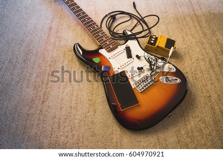 Set of music objects on electric single guitar, wide angle