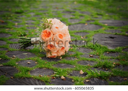 wedding bouquet on a green grass and logs