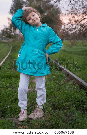 Beautiful little girl on the railroad 