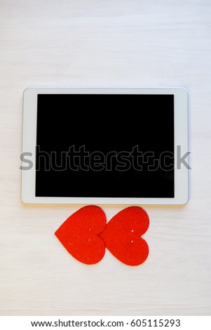 Top view of tablet PC and love red hearts decoration background. Valentines Day concept copy space flat lay image closeup
