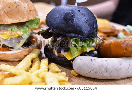 Black burger and french fries 