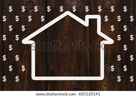 Paper house in rain of dollars on wooden background, money concept. Abstract conceptual image.