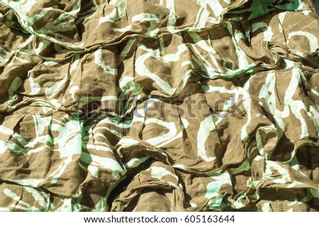Texture, background, pattern. Women's skirt. Fabric cotton protective color khaki. Textile fabric is dull brownish-yellow in color, in particular, a strong cotton cloth