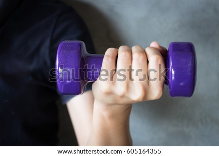 Woman Hand Holding Violet Dumbbell, stock photo