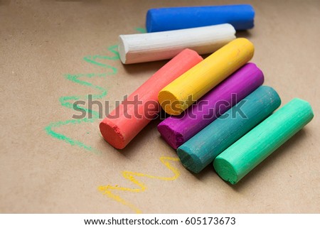 A set of pastel crayons on special paper for drawing. Horizontal close-up.