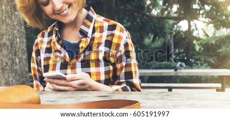 Hipster person holding in hands digital mobile smart phone, young girl smile reading on gadget on background nature landscape, mock up technology blur, female hands tourist using connect, sun flare