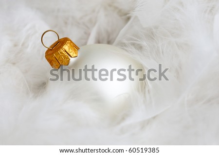 One white christmas bulb on white fluffy feathers