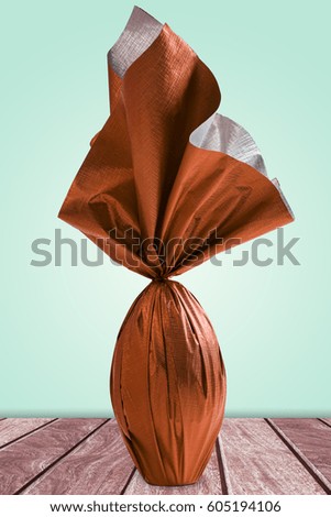 Brazilian Easter egg, on a wooden table on a green background.