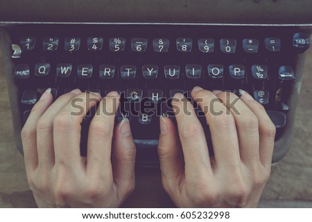 Hands writing on old typewriter,vintage style