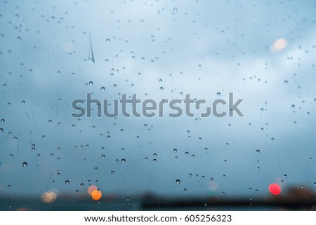 Close-up of water droplets on glass with bokeh