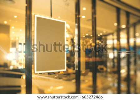 Side view of empty picture frame hanging on shop window. Ad concept