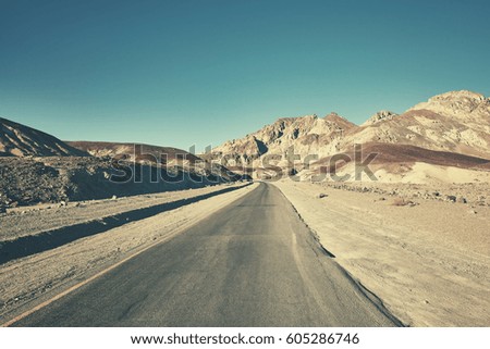 Retro toned picture of a desert road in Death Valley, California, USA.