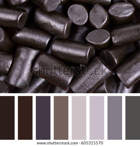 A background of cut pieces of black liquorice in a colour palette with complimentary colour swatches