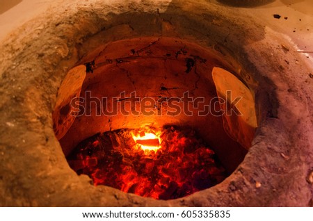 Bread in the Traditional Tandouri Oven Royalty-Free Stock Photo #605335835