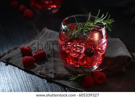 cocktail rosemary accompanied by raspberries, cranberries and Rosemary leaf 