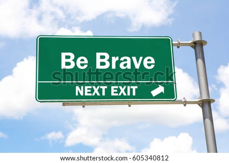 Green overhead road sign with a Be Brave Next Exit concept against a partly cloudy sky background.