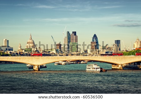 City of London in late afternoon light. This view includes: St. Paul`s Cathedral, The Gherkin, Tower 42, and Waterloo Bridge.
