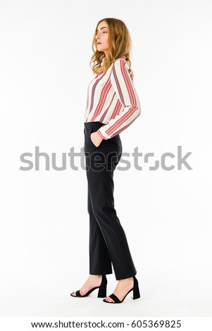 The attractive girl in trousers and shirt. It is on a white background
