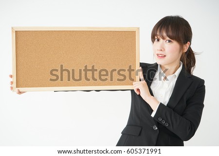 Young business woman holding board