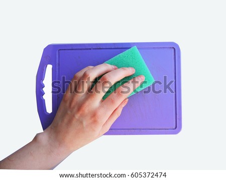 Woman hand holding a cleaning sponge. Green household cleaning sponge.  Cleaning service,spring cleaning concept. Flat lay, Top view.Housework concept.Yellow sponge isolated on white background.