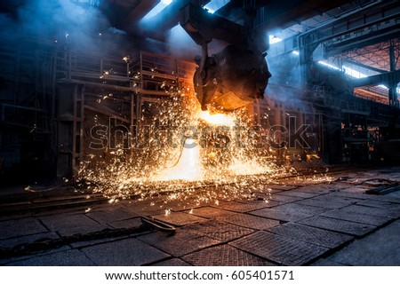 Pouring of liquid metal in open-hearth furnace Royalty-Free Stock Photo #605401571