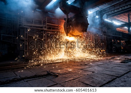 Pouring of liquid metal in open-hearth furnace Royalty-Free Stock Photo #605401613