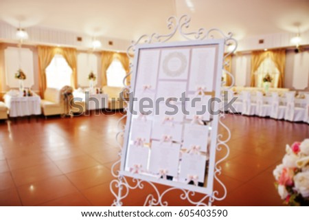 Blur photo of guest wedding board at restaurant.