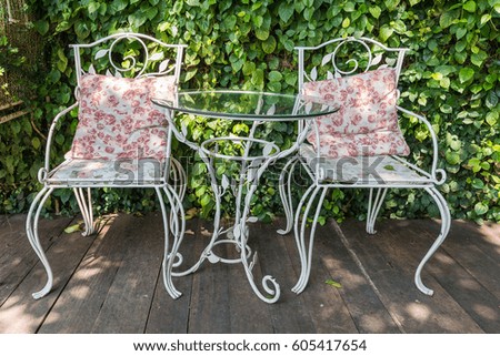 Modern white chair and table set up in the garden