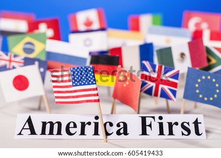 American flag is in front of the slogan America First and many flags of other countries. Royalty-Free Stock Photo #605419433
