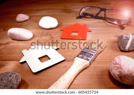 Sign Home, brush, glasses and stones - concept of building or repairing houses