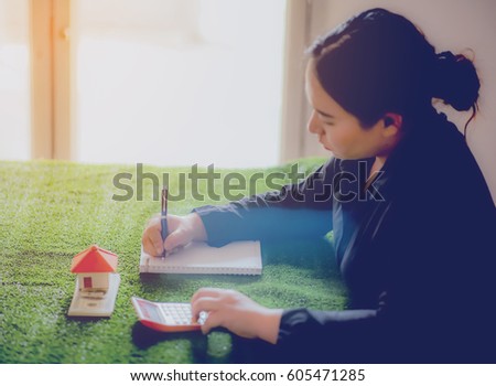 Woman signs purchase agreement for a house
