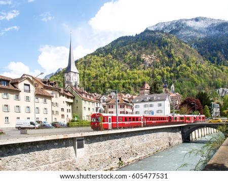 Chur, Switzerland: Panorama of the old town by train of the Rhaetian Railway in the foreground Royalty-Free Stock Photo #605477531