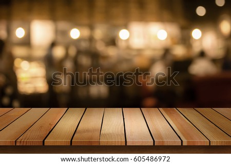 Wood table top on blur bokeh cafe background can be used for display or montage your products
