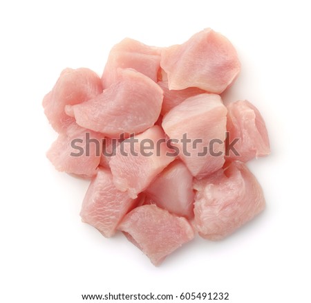 Top view of raw chicken fillet chunks isolated on white Royalty-Free Stock Photo #605491232