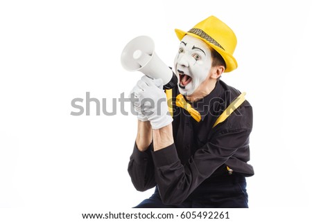 Portrait of a male mime artist, shouting or showing on a megaphone. Isolated on white background.