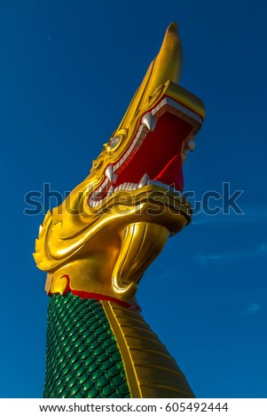 Biggest Magnificent statue Green and shiny  gold Na ga , Fairy tail animal in asia religion at navy blue sky.