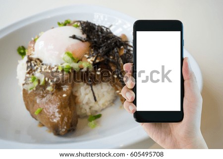 person's right hand using smart phone with blank screen on abstract blurred background of chashu don with egg onsen, japanese traditional Food