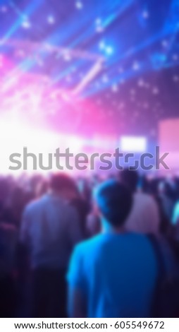 blur image of people in concert hall with live band.