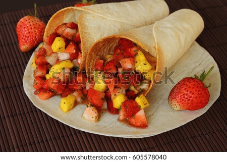 Burritos wraps with strawberry fruit salad Mexican fast food.