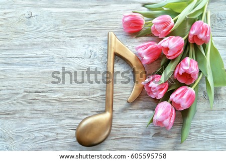 Tulips with notes on wooden background 