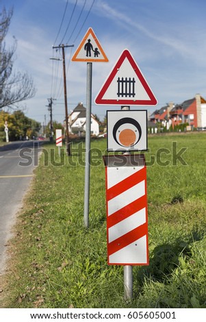 Warning road signs before the railroad crossing closeup, countryside