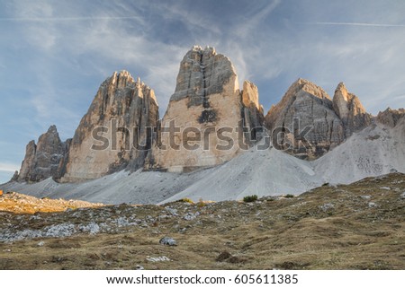 Famous italian hiking tourism trail in Tre Cime di Laveredo. View of amazing mountains with majesti blue sky background. Sun beans seep through the mountains.