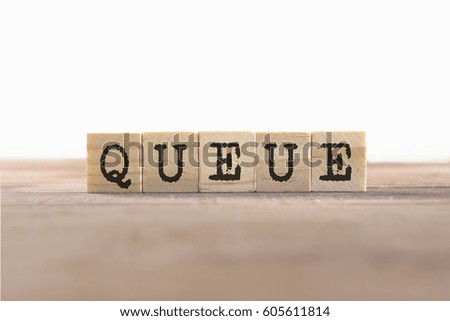 Queue Word Written In Wooden Cube