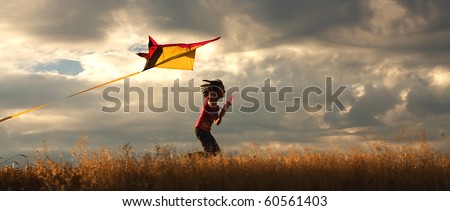 A panorama of a girl happily flying her kite. Royalty-Free Stock Photo #60561403
