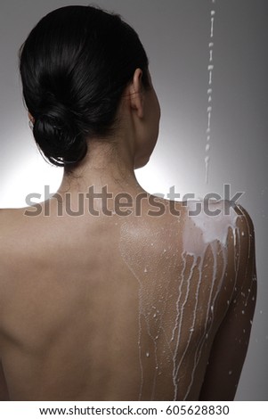 Milk being poured down a woman's back