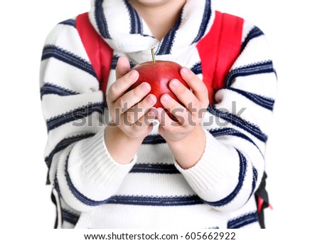 Cute little schoolboy with apple on white background, closeup