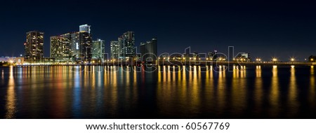 Wide angle view of the Venetian Causeway Drawbridge and Biscayne Bay in Downtown Miami in the late evening with colored reflections on the bay.