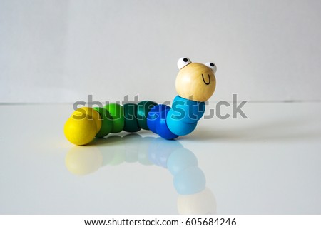 Closeup of wood, colorful, kids, toy caterpillar on the white background, suitable for babies and children up to 1 year. Concept motor.