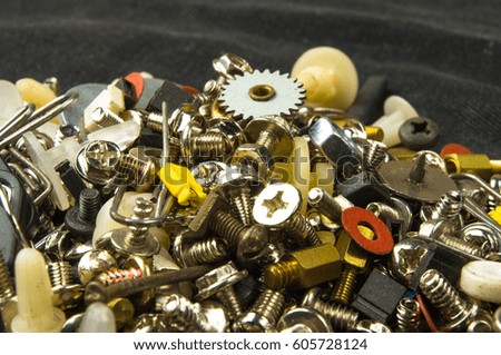 techno backgrounds - various bolts, screws, washers, nuts and other computer small fasteners on black fabric