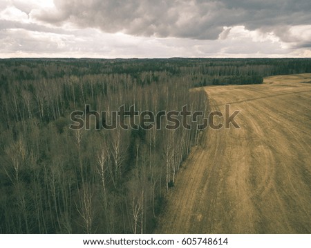 aerial view of rural area with fields and forests in cloudy spring day. latvia - vintage retro